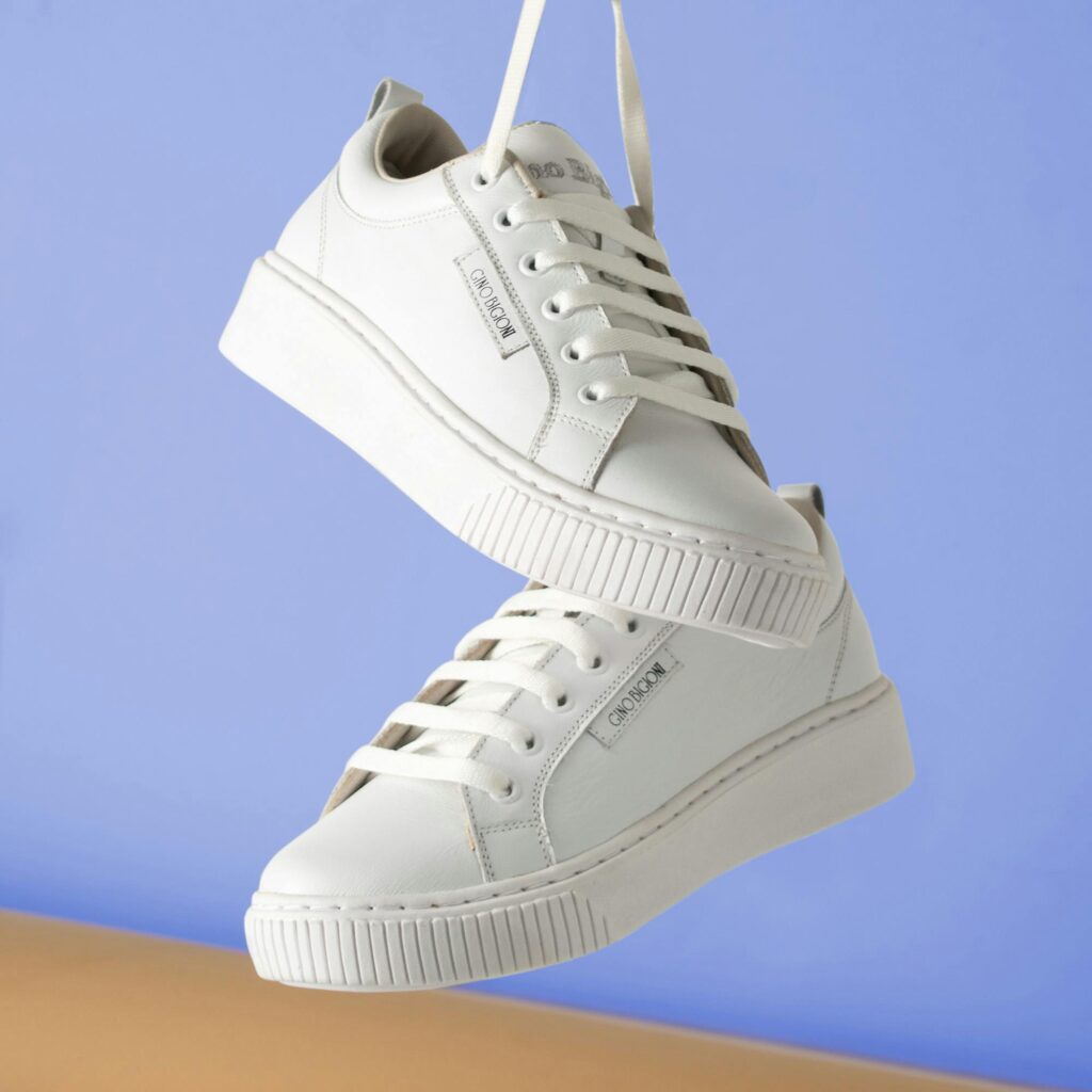 Minimalist leather white sneakers with clean low-top silhouette and rubber sole