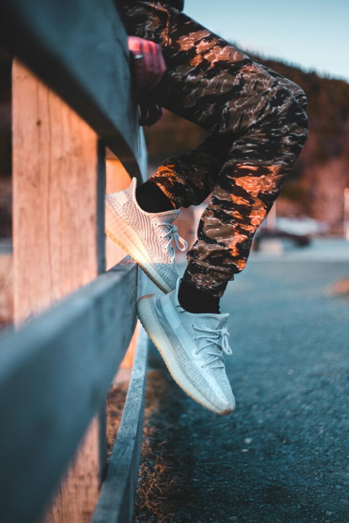 Lightweight white sneakers worn with summer shorts and linen shirt