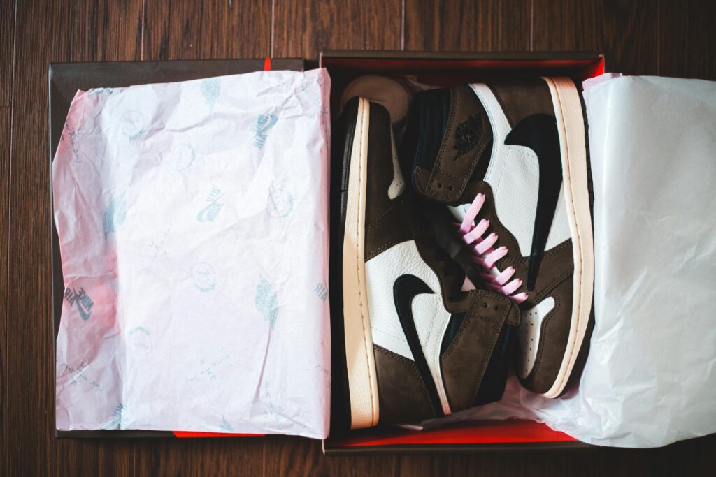 High-end luxury sneakers styled with oversized hoodie and distressed denim streetwear outfit