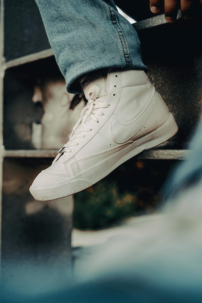 Urban streetwear look featuring high top sneakers paired with jeans and a casual jacket.